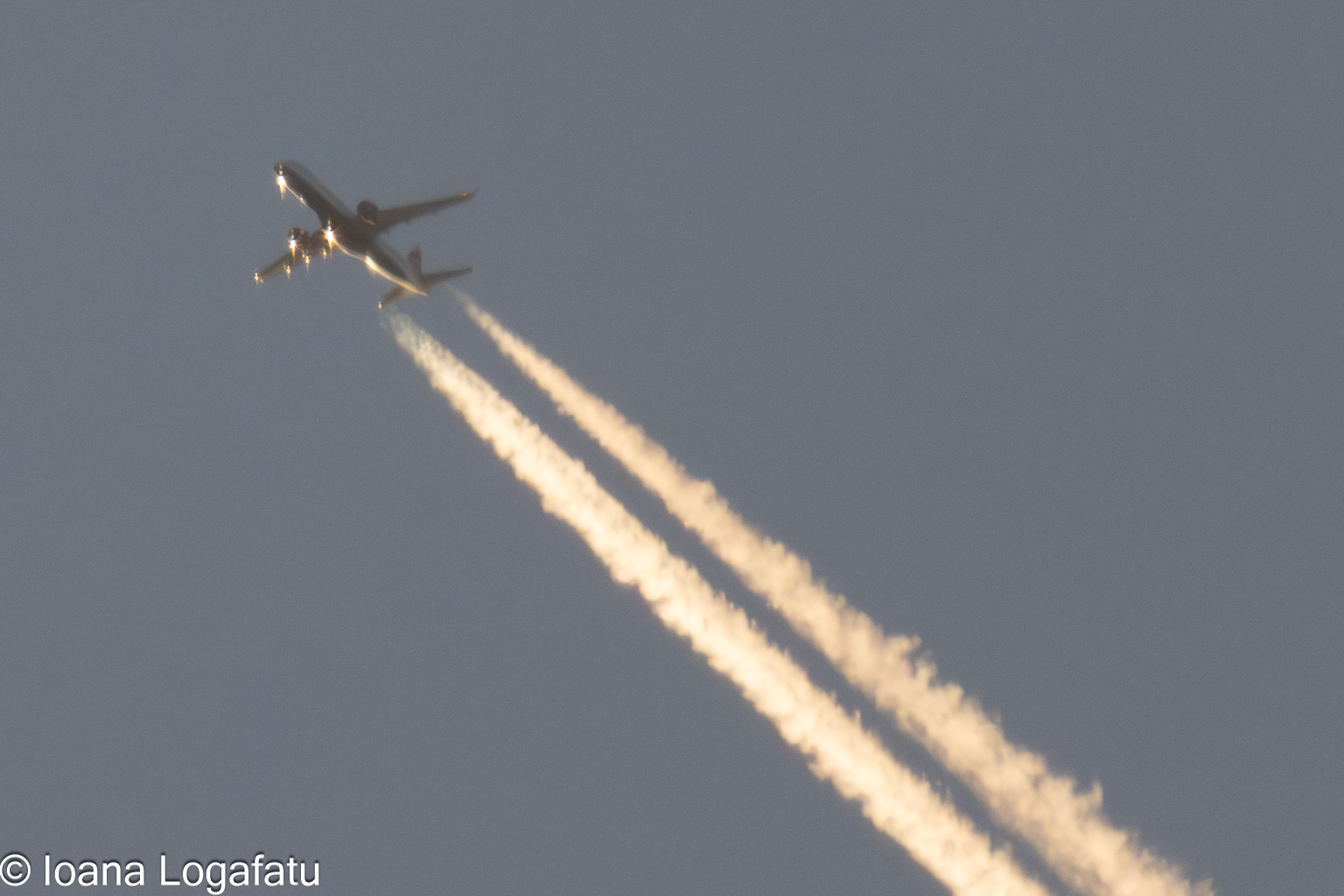 Jet soaring high, leaving trails behind